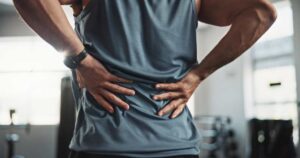 Chicago back injury attorney - man holding his lower back due to an injury