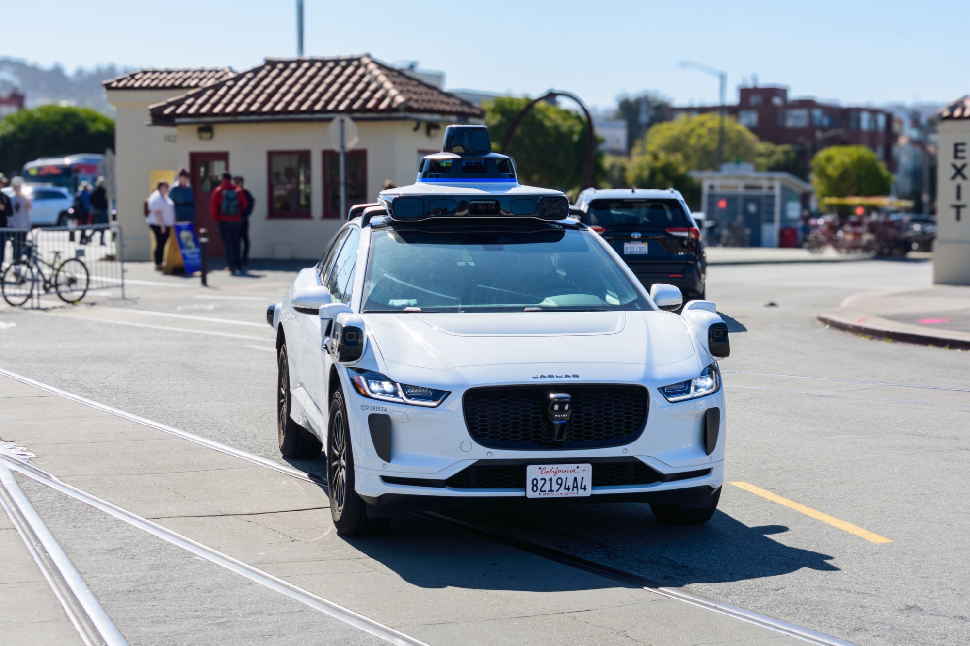 Chicago autonomous vehicle injury lawyer - Waymo One Jaguar driverless autonomous car equipped with lidar sensors and cameras drives on a road.