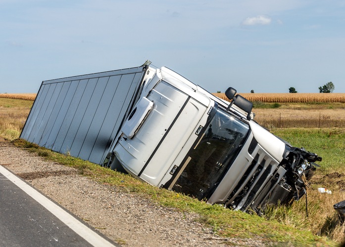Chicago truck rollover accident attorneys- The large truck lies in a side ditch after the road accident.