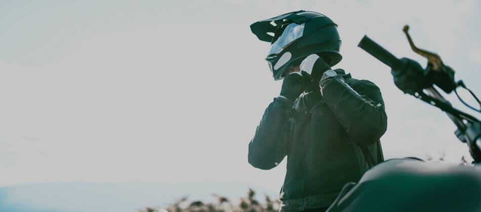 Motorcyclist taking off helmet