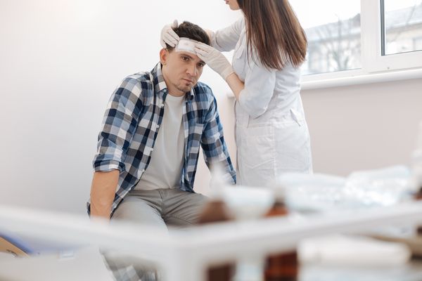 A man getting checked out by a doctor after a TBI without loss of consciousness