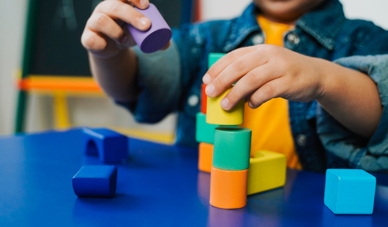 child playing with wood blocks at daycare - can you sue a Chicago daycare for your child’s injury?