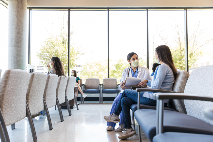 doctor with a patient in a medical facility waiting room - Chicago medical malpractice lawyer