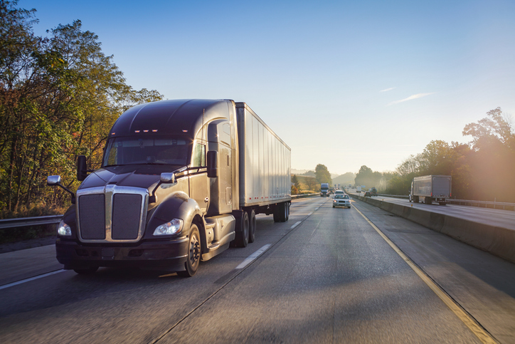 truck driving next to a car - when should you get a lawyer for a truck accident in Gurnee, IL?