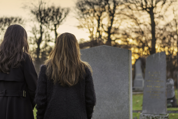 grieving family members at a grave site - What rights do surviving family members have after wrongful death?